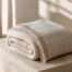 Folded ivory Dune Weave Winter Throw showing woven texture and fringe
